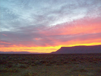 Scenic view of dramatic sky over land