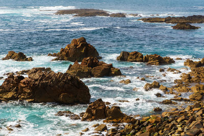 Rocky atlantic ocean coastline with pure turquoise water.