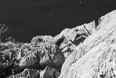 High angle view of rocks on sea shore