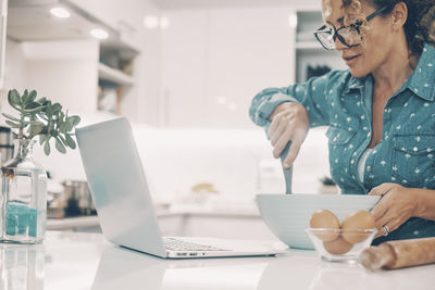 Young woman using laptop at office