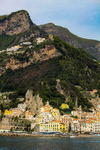 Scenic view of sea and buildings in town