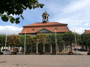 Traditional building by street against sky