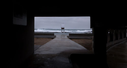 Scenic view of sea and buildings seen through window