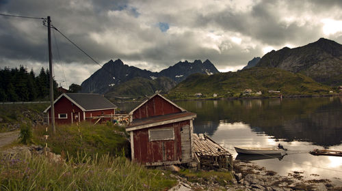 Built structure by lake against sky