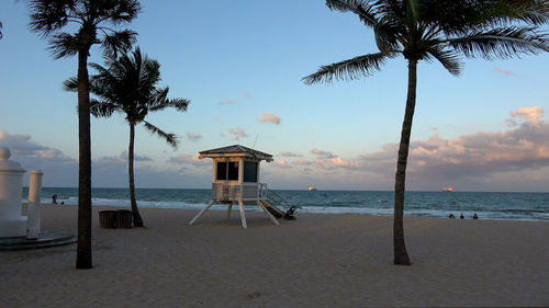 Lifeguard hut on beach against sky