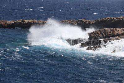 Sea waves splashing on rocks