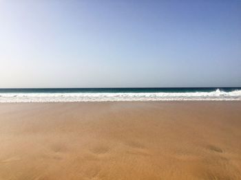 Scenic view of beach against clear sky