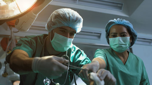 Side view of doctor examining patient in laboratory