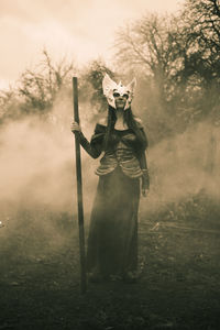 Full length of woman in costume standing on field