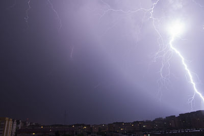 Lightning in sky over city at night