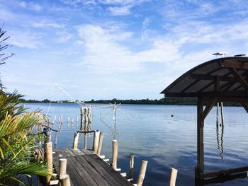 Pier on lake against sky