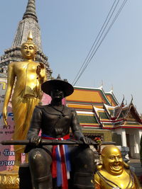 Low angle view of statue against temple