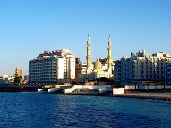 Sea with buildings in background