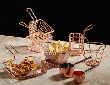 Close-up of wicker basket on table against black background