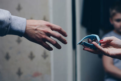 Midsection of man holding mobile phone