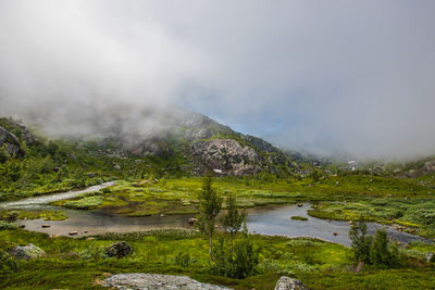 Scenic view of lake and mountains against sky