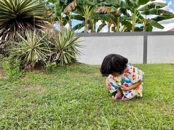 Boy sitting on grass