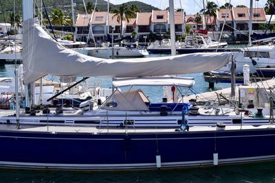 Sailboats moored at harbor