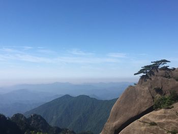 Scenic view of mountains against blue sky