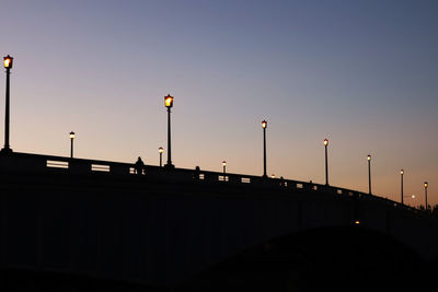 Silhouette bridge against sky during sunset