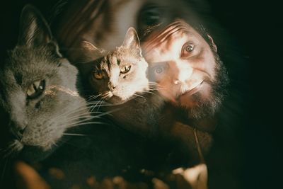 Double exposure of man and cat