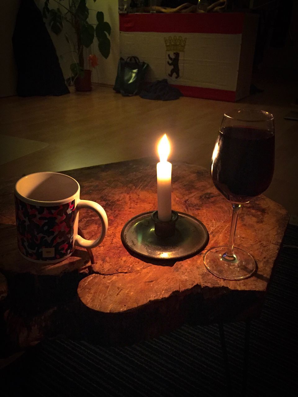 CLOSE-UP OF ILLUMINATED CANDLES ON TABLE