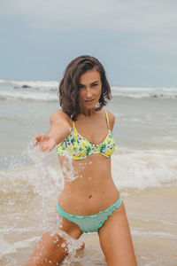 Happy woman on beach against sea