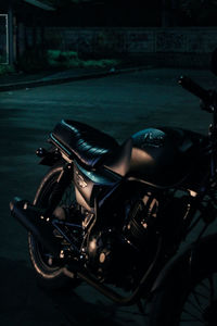 Close-up of bicycle parked on road at night