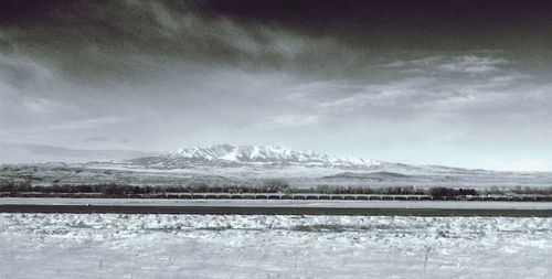Scenic view of snow covered mountains against sky