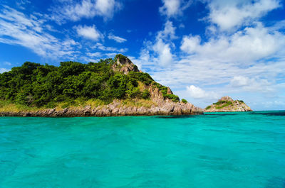 Idyllic shot of sea by old providence against cloudy sky