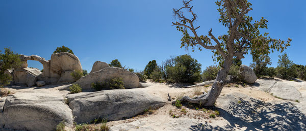 Rock formations against clear blue sky