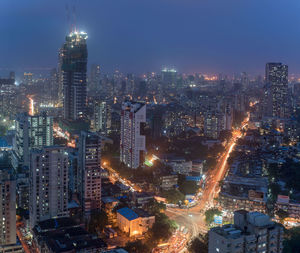 High angle view of illuminated city buildings at night