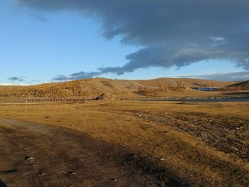 Scenic view of arid landscape against sky