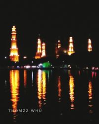 Reflection of buildings in water at night