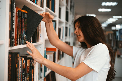 Young woman looking at book