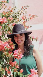 Portrait of smiling woman with pink flower