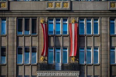 Low angle view of austrian flags hanging on building