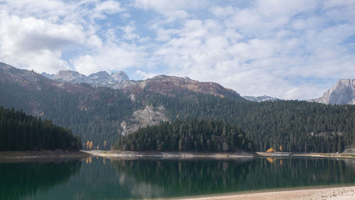 Scenic view of lake and mountains against sky