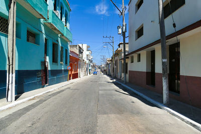 Typical and deserted street of cuba with old cars in direct sunlight