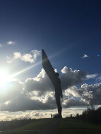 Silhouette person standing on field against sky