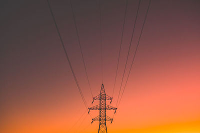 Electric power lines in the evening sun. electric energy transmission pole in vibrant background