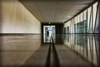 Man walking in corridor of building