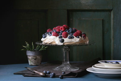 Fruit cake on stand over table