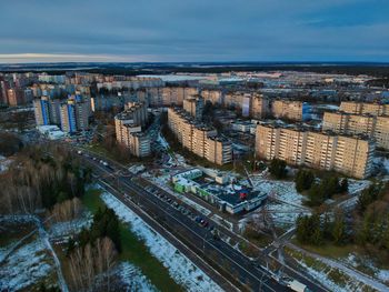 High angle view of road by buildings against sky in city