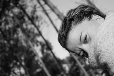 Close-up portrait of woman against sky