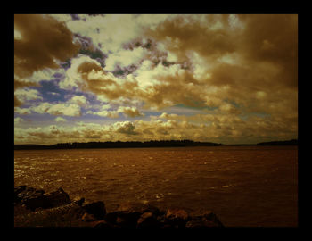 Scenic view of sea against cloudy sky