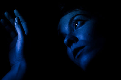 Close-up of human hand against black background