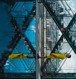 Upside down image of mid adult man reflecting on swimming pool