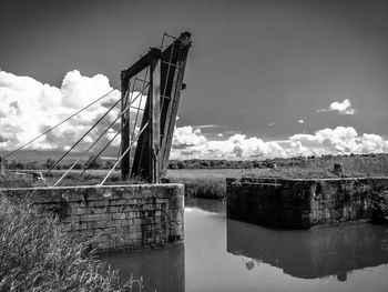Low angle view of abandoned bridge against sky