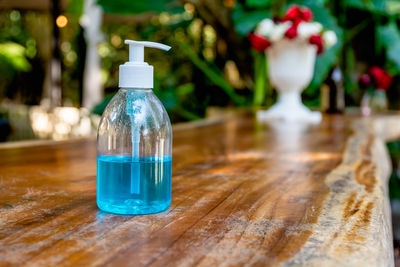 Close-up of small glass bottle on table at home